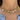 A close-up of a gold charm necklace worn on a person's neck, featuring multiple small heart and bow-shaped charms, with a gray top visible at the bottom.