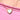 A close-up of a person wearing a delicate gold chain necklace with a small heart-shaped pendant featuring a mother of pearl white inlay