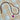 A gold-toned tennis-style necklace with purple rhinestones and a pink heart-shaped charm containing a purple heart, laid flat on a beige and white checkered fabric background.