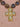 A gold cross pendant necklace with clear faceted crystals, attached to a strand of dark brown heart-shaped beads with small gold spacer beads.