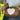 A brown vegan-leather crossbody bag with a large white heart on the front.